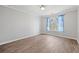 Bright bedroom features wood floors, a large window for natural light, and neutral walls at 305 Brassy Ct, Alpharetta, GA 30022