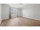 Bright bedroom features wood floors, a large window for natural light, and neutral walls at 305 Brassy Ct, Alpharetta, GA 30022