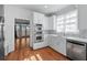 Kitchen featuring stainless steel appliances, hardwood floors, and bright windows at 305 Brassy Ct, Alpharetta, GA 30022