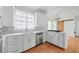 Bright kitchen with white cabinets, stainless steel appliances, and hardwood floors at 305 Brassy Ct, Alpharetta, GA 30022