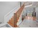 Staircase leading to a living room with hardwood floors and a fireplace at 305 Brassy Ct, Alpharetta, GA 30022