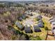 Aerial view of a cul-de-sac neighborhood surrounded by lush greenery and mature trees at 325 Nutwood Trce, Locust Grove, GA 30248