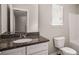 Bathroom featuring a granite vanity, toilet, and window at 325 Nutwood Trce, Locust Grove, GA 30248