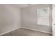 Bedroom featuring neutral walls and carpet, and a window at 325 Nutwood Trce, Locust Grove, GA 30248