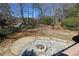 Backyard with stone paver patio and fire pit offering an inviting outdoor entertainment space at 3894 Stone Lake Nw Dr, Kennesaw, GA 30152