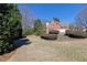 Lovely green lawn featuring manicured bushes, blue sky and a view of a red brick house at 3894 Stone Lake Nw Dr, Kennesaw, GA 30152