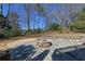 Backyard stone patio with fire pit at 3894 Stone Lake Nw Dr, Kennesaw, GA 30152