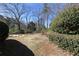 View of a sprawling backyard featuring a lush lawn, mature trees, and ample space for recreation at 3894 Stone Lake Nw Dr, Kennesaw, GA 30152