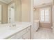 Bathroom featuring a neutral color scheme, a white vanity, white tile floor, and a framed mirror at 3894 Stone Lake Nw Dr, Kennesaw, GA 30152