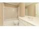 Bathroom with a tub/shower combo, and a white vanity featuring crystal knobs and faucets at 3894 Stone Lake Nw Dr, Kennesaw, GA 30152