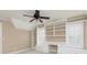 Bright bedroom with white built-in bookshelves and a desk, complemented by a modern ceiling fan at 3894 Stone Lake Nw Dr, Kennesaw, GA 30152