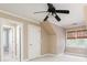 Bright bedroom featuring neutral paint, plush carpet, a ceiling fan, and a window with woven shades at 3894 Stone Lake Nw Dr, Kennesaw, GA 30152