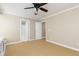 Neutral bedroom featuring a ceiling fan, closet, and ensuite bathroom at 3894 Stone Lake Nw Dr, Kennesaw, GA 30152