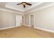 Bedroom with neutral walls, trey ceiling, and multiple doors at 3894 Stone Lake Nw Dr, Kennesaw, GA 30152