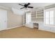 Neutral bedroom featuring a ceiling fan and built-in shelving units with window seats at 3894 Stone Lake Nw Dr, Kennesaw, GA 30152