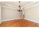 Dining room with hardwood floors, elegant chandelier, and views of the yard at 3894 Stone Lake Nw Dr, Kennesaw, GA 30152