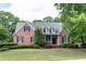 Charming brick home featuring a manicured lawn, symmetrical design, and a welcoming entrance at 3894 Stone Lake Nw Dr, Kennesaw, GA 30152