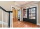 Elegant foyer featuring hardwood floors, staircase, and glass paned french doors at 3894 Stone Lake Nw Dr, Kennesaw, GA 30152