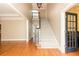 Spacious foyer with gleaming hardwood floors, a staircase, and elegant trim work at 3894 Stone Lake Nw Dr, Kennesaw, GA 30152
