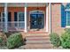 Inviting front porch with brick steps, white columns, and well-maintained landscaping at 3894 Stone Lake Nw Dr, Kennesaw, GA 30152