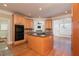 Gourmet kitchen with island cooktop, wood cabinets, and views into the breakfast nook at 3894 Stone Lake Nw Dr, Kennesaw, GA 30152