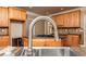 A close-up shot of a kitchen sink, with wood cabinets and granite countertops at 3894 Stone Lake Nw Dr, Kennesaw, GA 30152