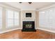 Cozy living room with fireplace, hardwood floors, and bright windows at 3894 Stone Lake Nw Dr, Kennesaw, GA 30152