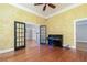 Spacious living room featuring hardwood floors, piano, and glass-paned french doors at 3894 Stone Lake Nw Dr, Kennesaw, GA 30152