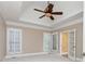 Main bedroom with trey ceilings, fan, plush carpeting, and plenty of natural light at 3894 Stone Lake Nw Dr, Kennesaw, GA 30152