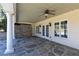 Covered patio with stone flooring, ceiling fan, and swing, perfect for outdoor relaxation and entertaining at 3894 Stone Lake Nw Dr, Kennesaw, GA 30152