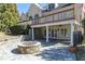 Outdoor patio featuring a stone fire pit and covered porch with stone columns at 3894 Stone Lake Nw Dr, Kennesaw, GA 30152