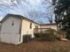 Exterior view of home, including a wooden deck overlooking the landscaped backyard with mature trees at 1753 Lee St, Decatur, GA 30035
