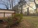 Exterior view of a home, including a wooden deck overlooking the landscaped backyard with mature trees at 1753 Lee St, Decatur, GA 30035