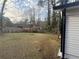 Spacious backyard featuring a grassy lawn, wood fence, and a fire pit at 1753 Lee St, Decatur, GA 30035