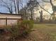 Nice, grassy backyard with a wood deck and stairs leading from the house at 1753 Lee St, Decatur, GA 30035