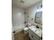 Bright bathroom featuring a subway tiled shower-tub combo, granite vanity, and updated fixtures at 1753 Lee St, Decatur, GA 30035