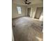 Bright bedroom featuring a ceiling fan, large windows with natural light, neutral carpet and closets at 1753 Lee St, Decatur, GA 30035