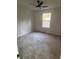 Bedroom featuring large windows and neutral carpet, offering ample natural light and a ceiling fan at 1753 Lee St, Decatur, GA 30035