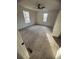 Spacious bedroom with two windows, neutral paint, carpet, and a modern ceiling fan with light at 1753 Lee St, Decatur, GA 30035