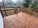 View of a wood deck with matching wood railings overlooking the home's backyard at 1753 Lee St, Decatur, GA 30035