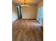Dining area featuring modern chandelier, wood-look floors and sliding door at 1753 Lee St, Decatur, GA 30035