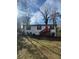 Charming single story home with white siding, black shutters, and a bright red front door at 1753 Lee St, Decatur, GA 30035