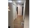 Hallway with new floors and fresh paint leads to multiple rooms with bedrooms and closets at 1753 Lee St, Decatur, GA 30035