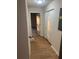 Hallway with new floors and fresh paint leads to multiple rooms, including a bedroom with natural light at 1753 Lee St, Decatur, GA 30035