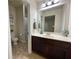 Bathroom featuring dark wood cabinets, a sink, and a shower-tub combination behind a floral curtain at 2481 Tack Hill Ct, Dacula, GA 30019