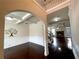 Inviting foyer with coffered ceilings, wood floors, wainscoting, an arched entryway, and a decorative tree wall hanging at 2481 Tack Hill Ct, Dacula, GA 30019