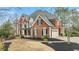 Charming two-story home with a two-car garage and mature landscaping in a suburban neighborhood at 720 Weybridge Pl, Alpharetta, GA 30022