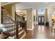 Grand foyer with hardwood floors, staircase, and a view of the formal dining room at 720 Weybridge Pl, Alpharetta, GA 30022