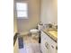 Powder room featuring a granite vanity top, toilet, neutral walls and tile flooring at 526 Blue Mountain Rise, Canton, GA 30114