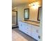 Bathroom featuring double sink vanity with granite countertops, modern fixtures, and tiled floors at 526 Blue Mountain Rise, Canton, GA 30114